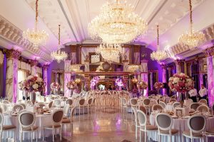 Luxurious dinner hall with large crystal chandeliers hanging from the ceiling